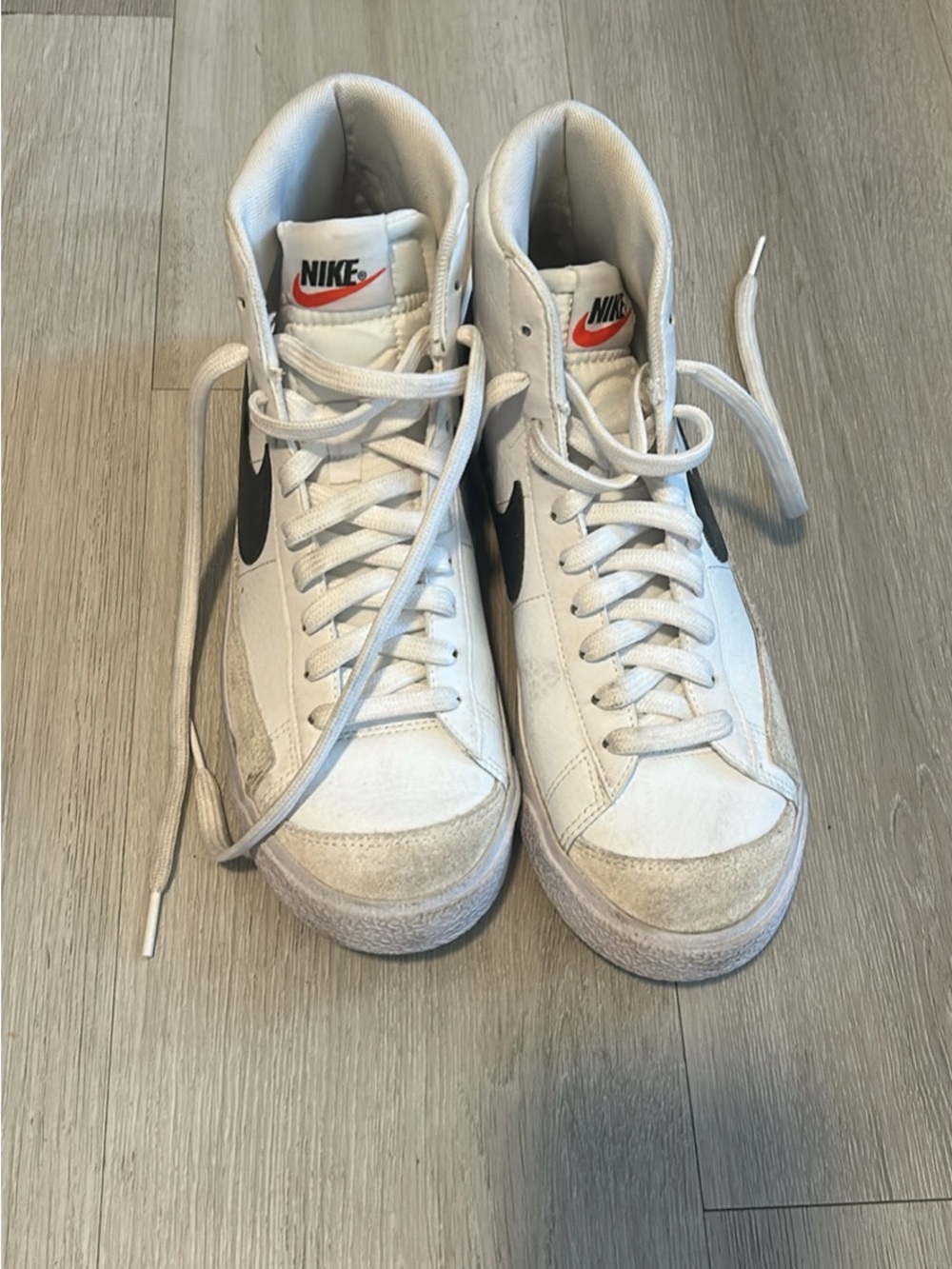 Nike White High-Top Sneakers with Black Swoosh and Red Logo